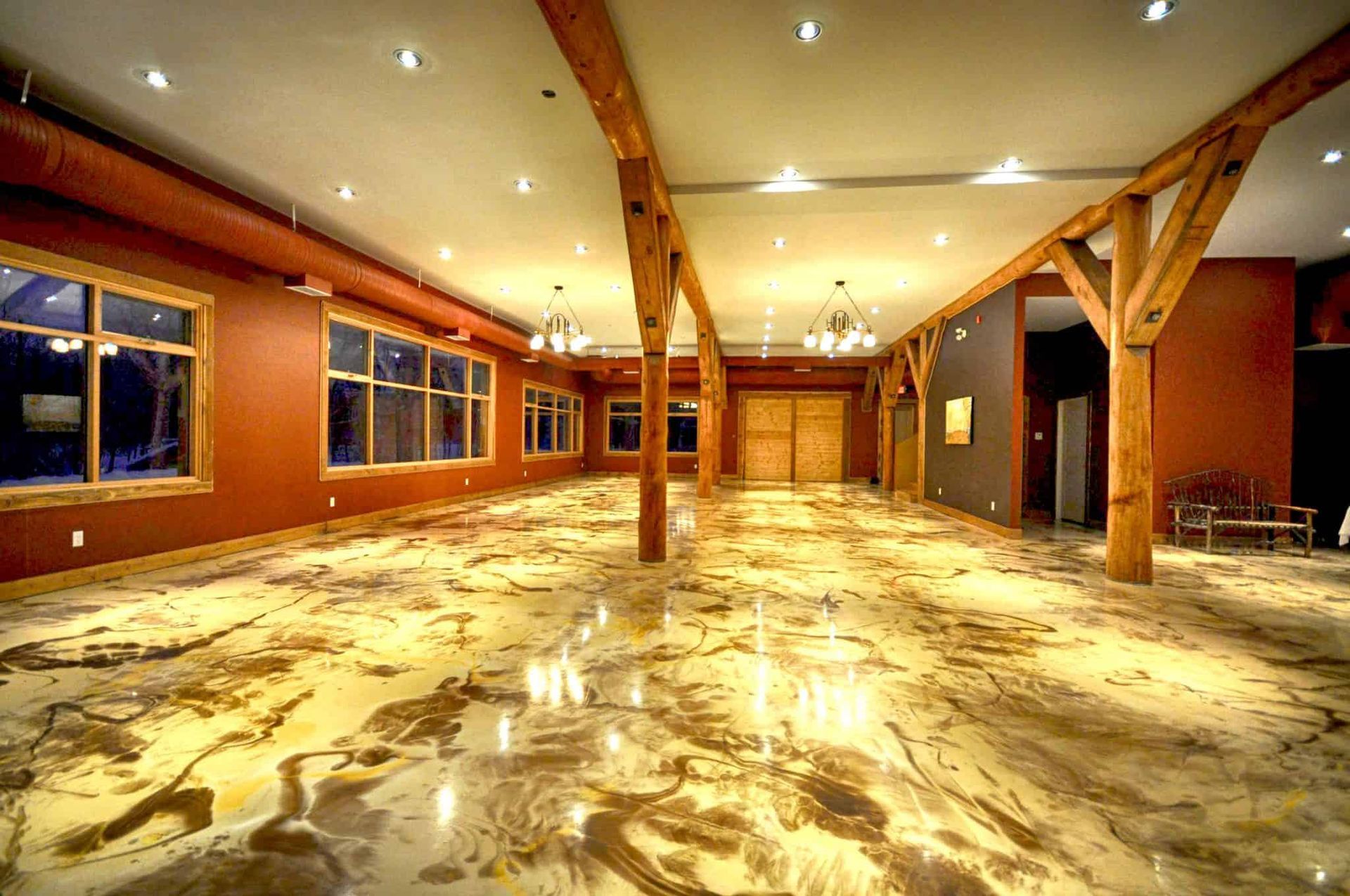 A large room with a marble floor and wooden beams