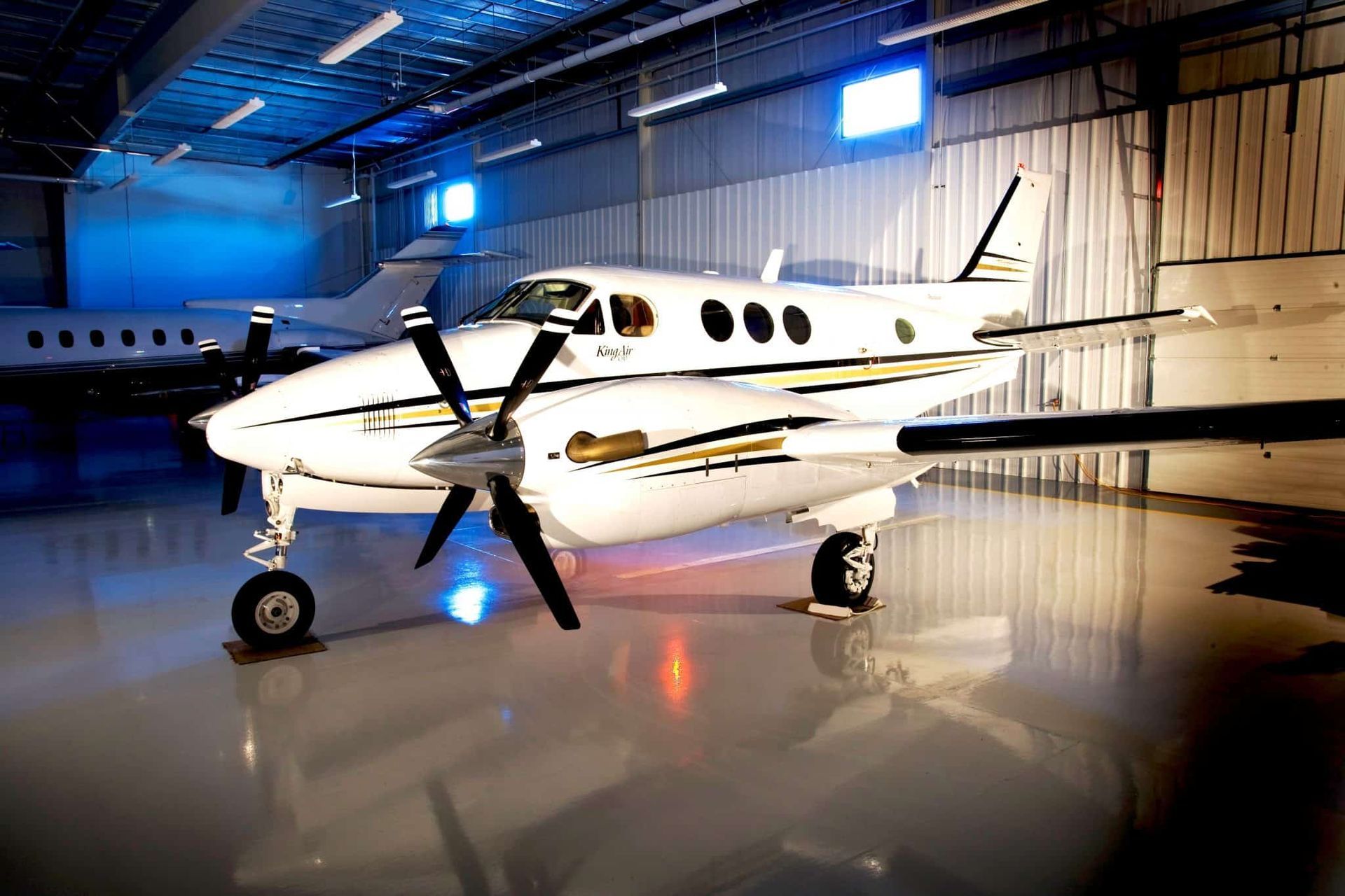 A small propeller plane is parked in a hangar