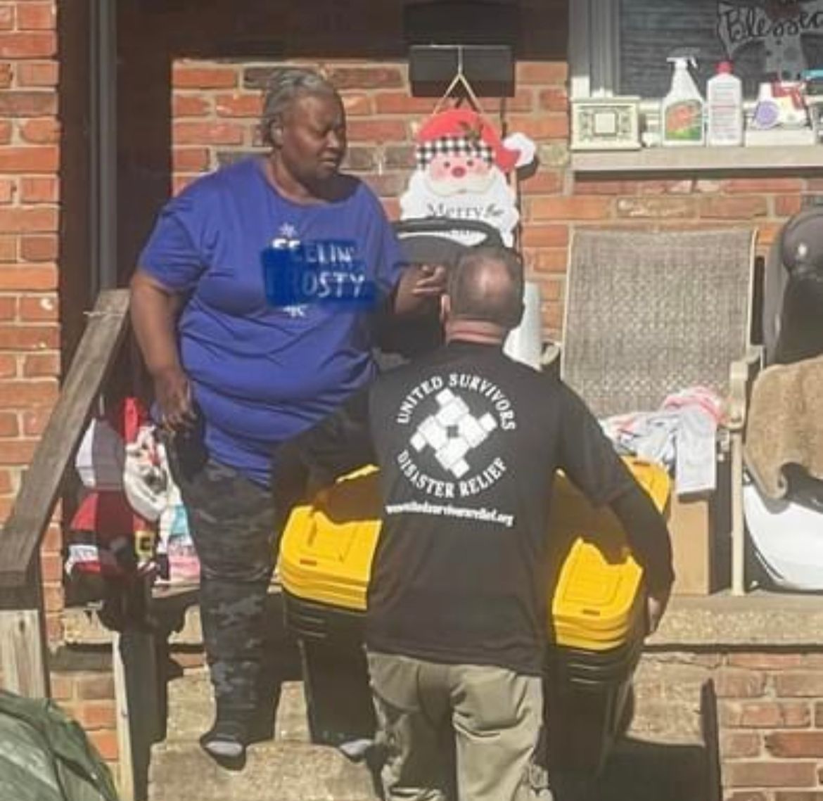 A man wearing a black shirt that says united survivors on it