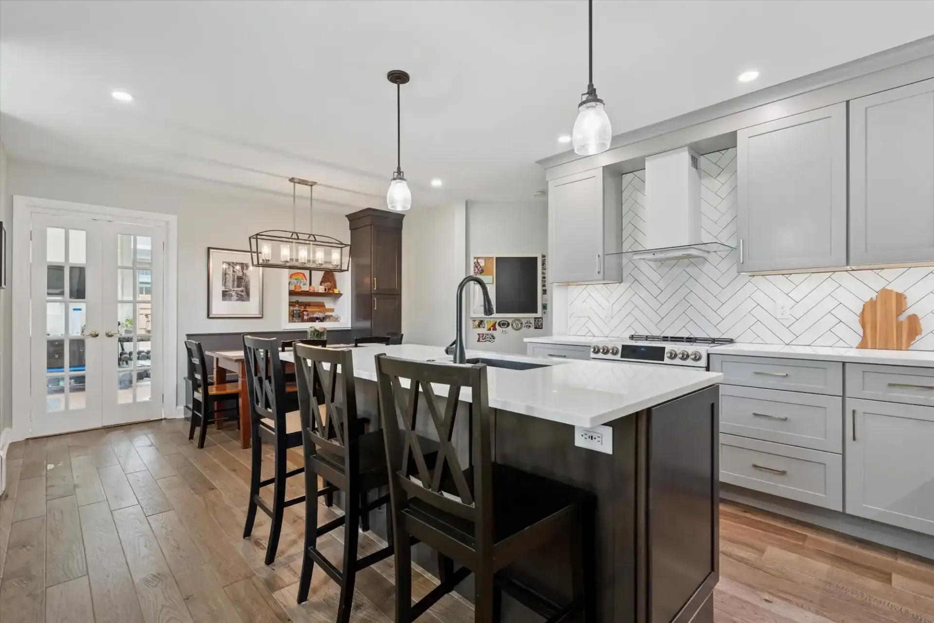 A kitchen with a large island and a dining room in the background.