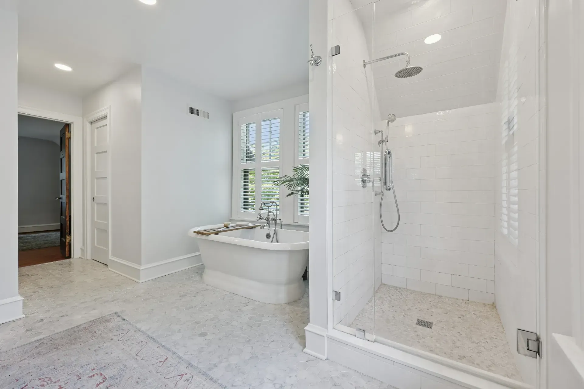 A bathroom with a bathtub and a walk in shower.