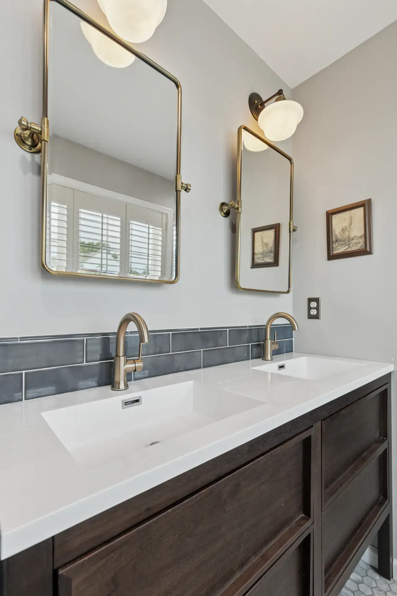 A bathroom with two sinks and two mirrors.