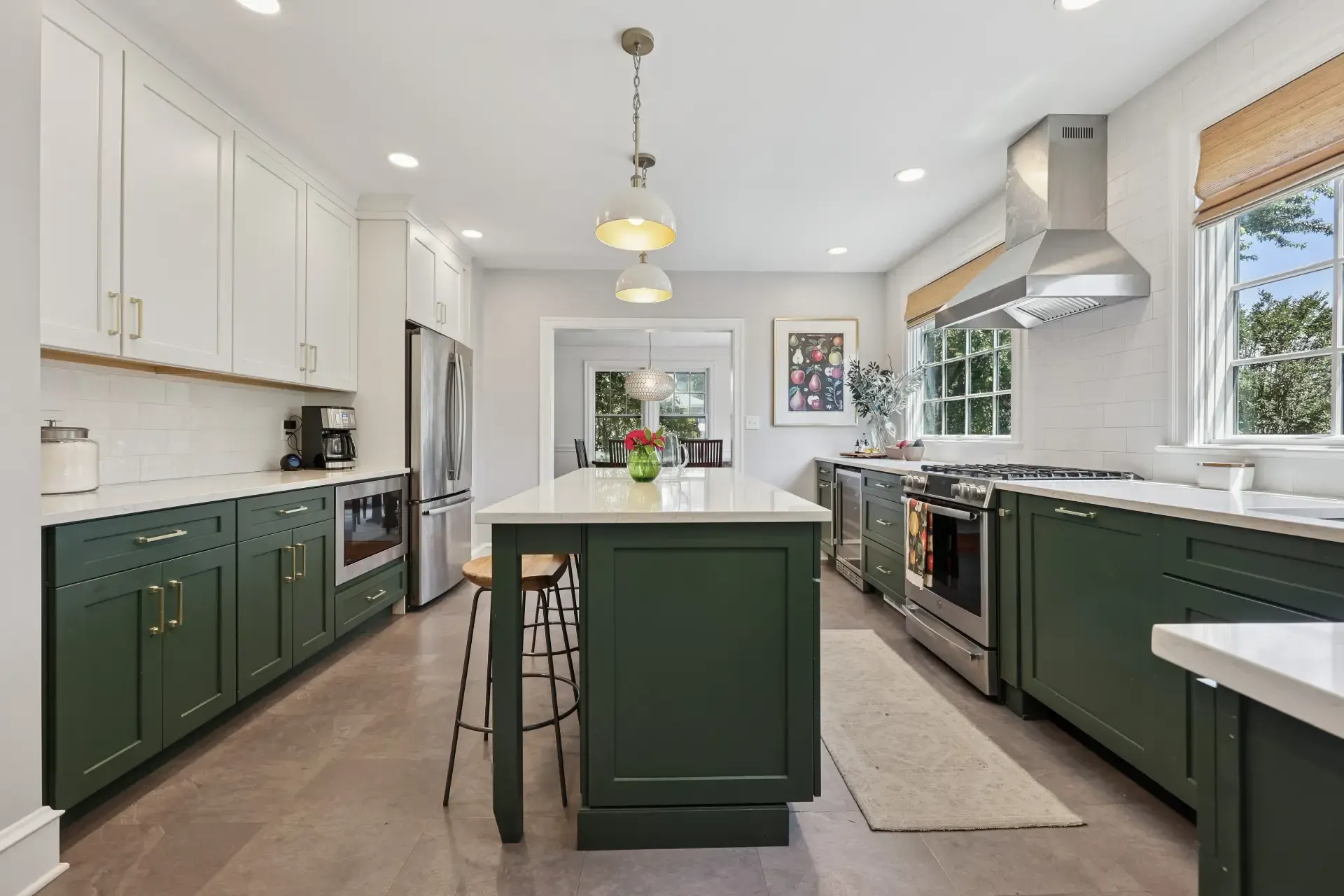 A kitchen with green cabinets and stainless steel appliances