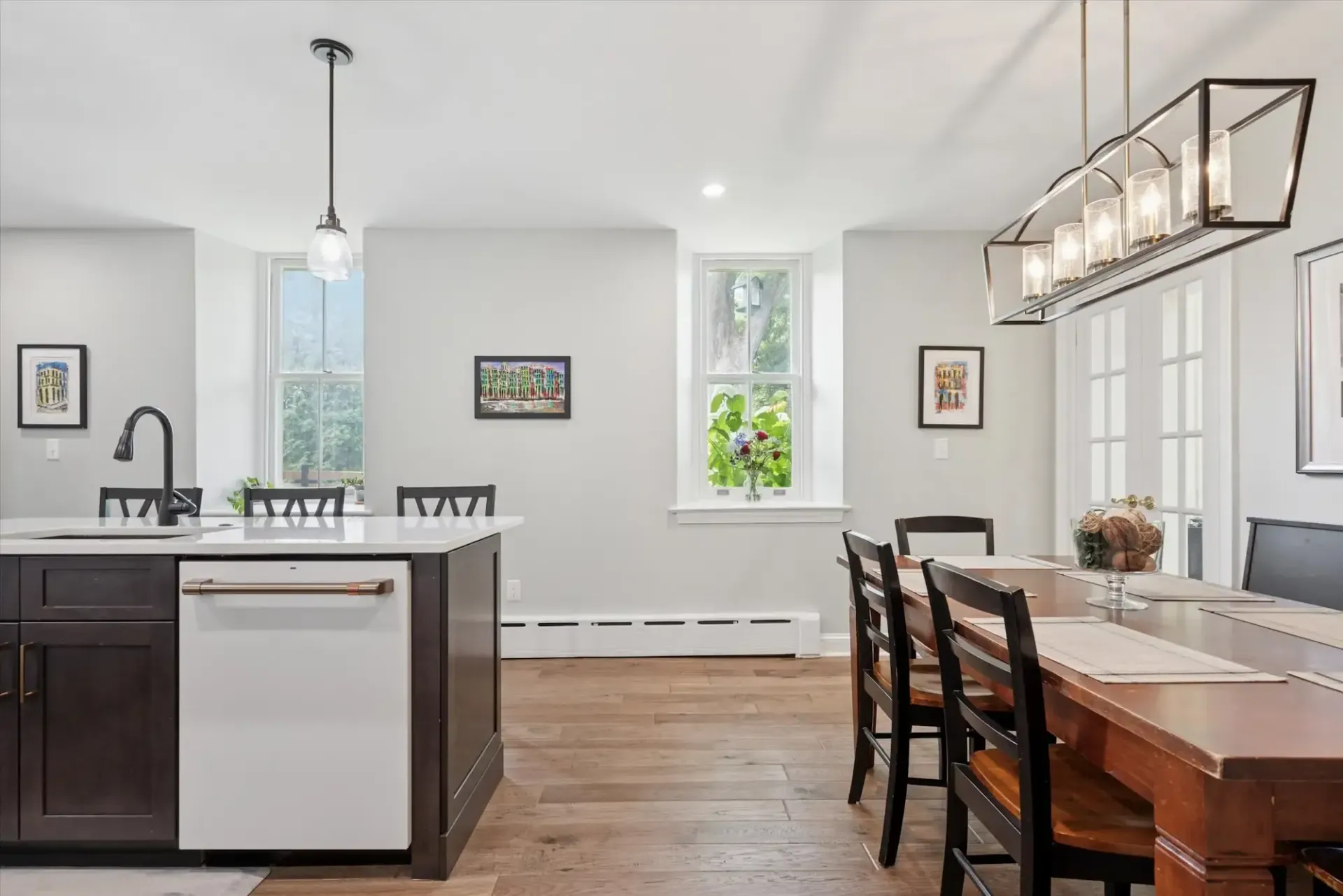 A kitchen with a table and chairs and a sink.