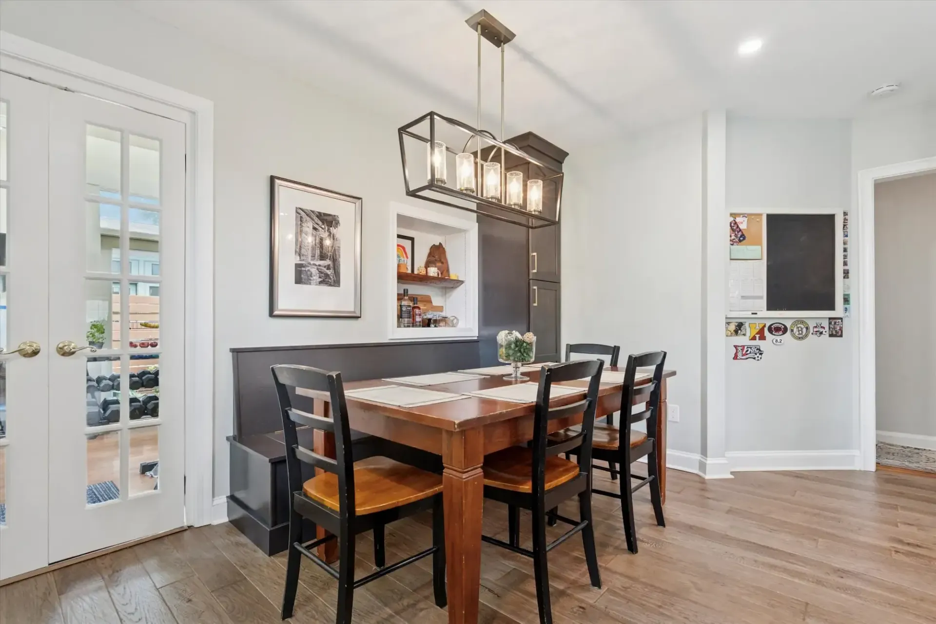 A dining room with a table and chairs and a chandelier.