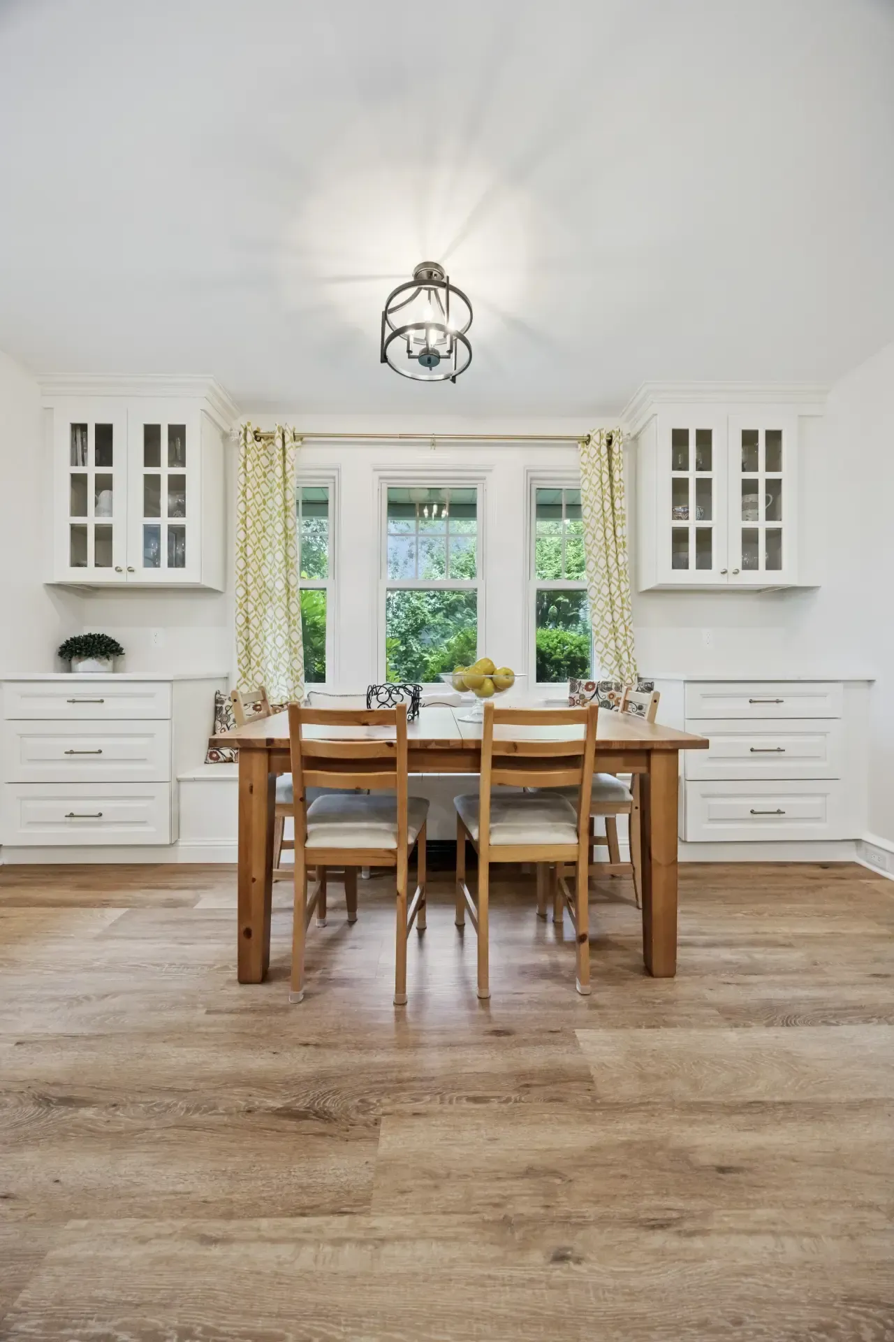 A dining room with a wooden table and chairs