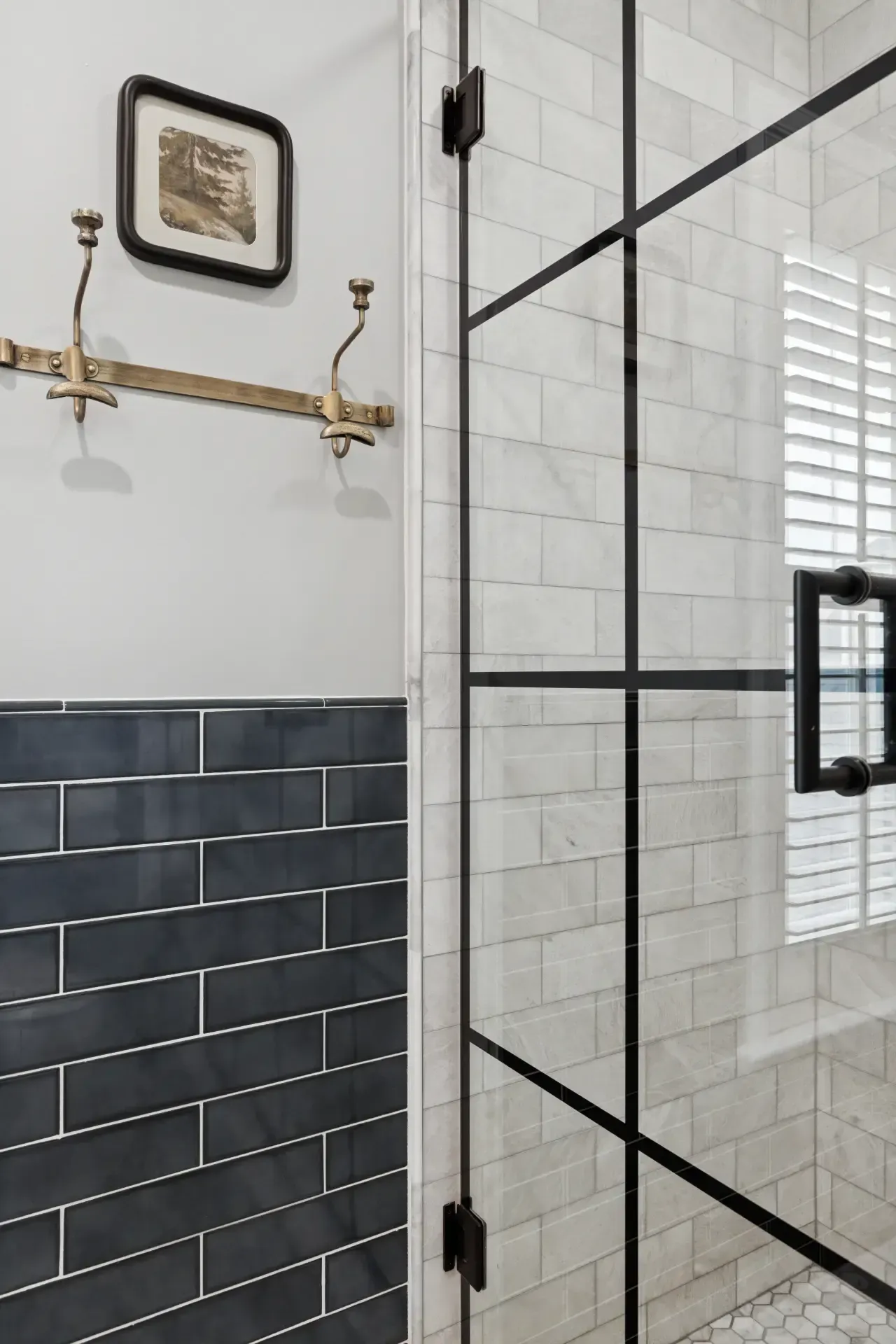 There is a picture on the wall above the shower door.