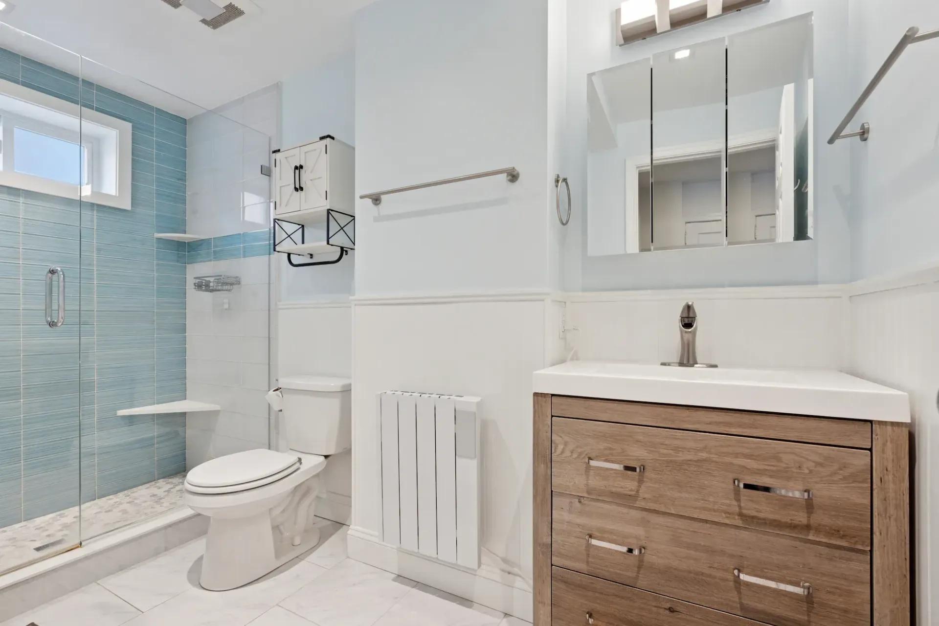 A bathroom with a toilet , sink , and shower.