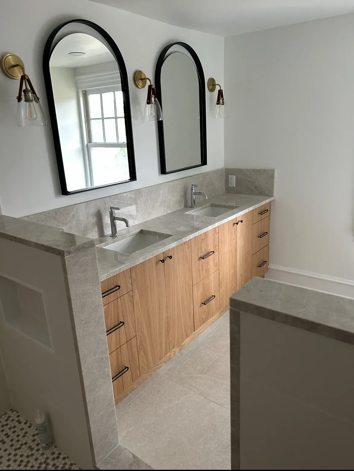 A bathroom with two sinks and two mirrors.