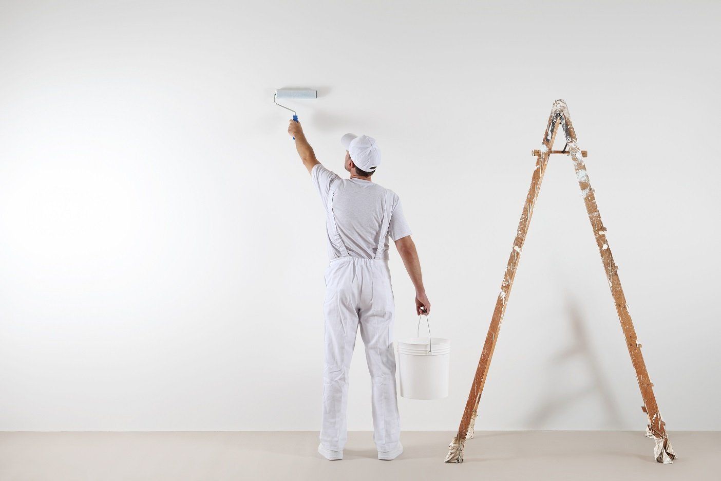 A house painters painting a residential wall in white colour paint in Hobart, TAS.