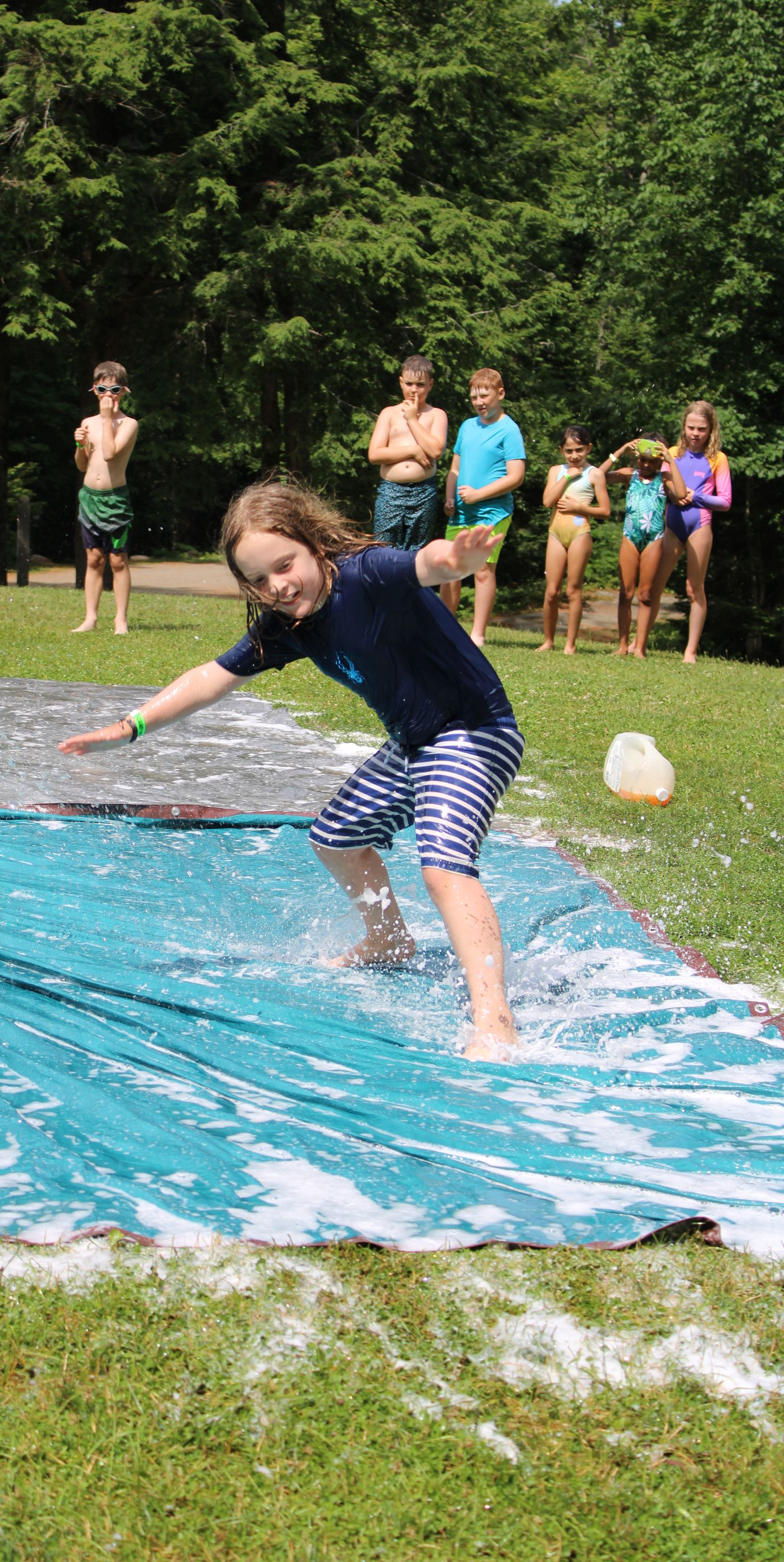 Campers having fun on a hot day with water play