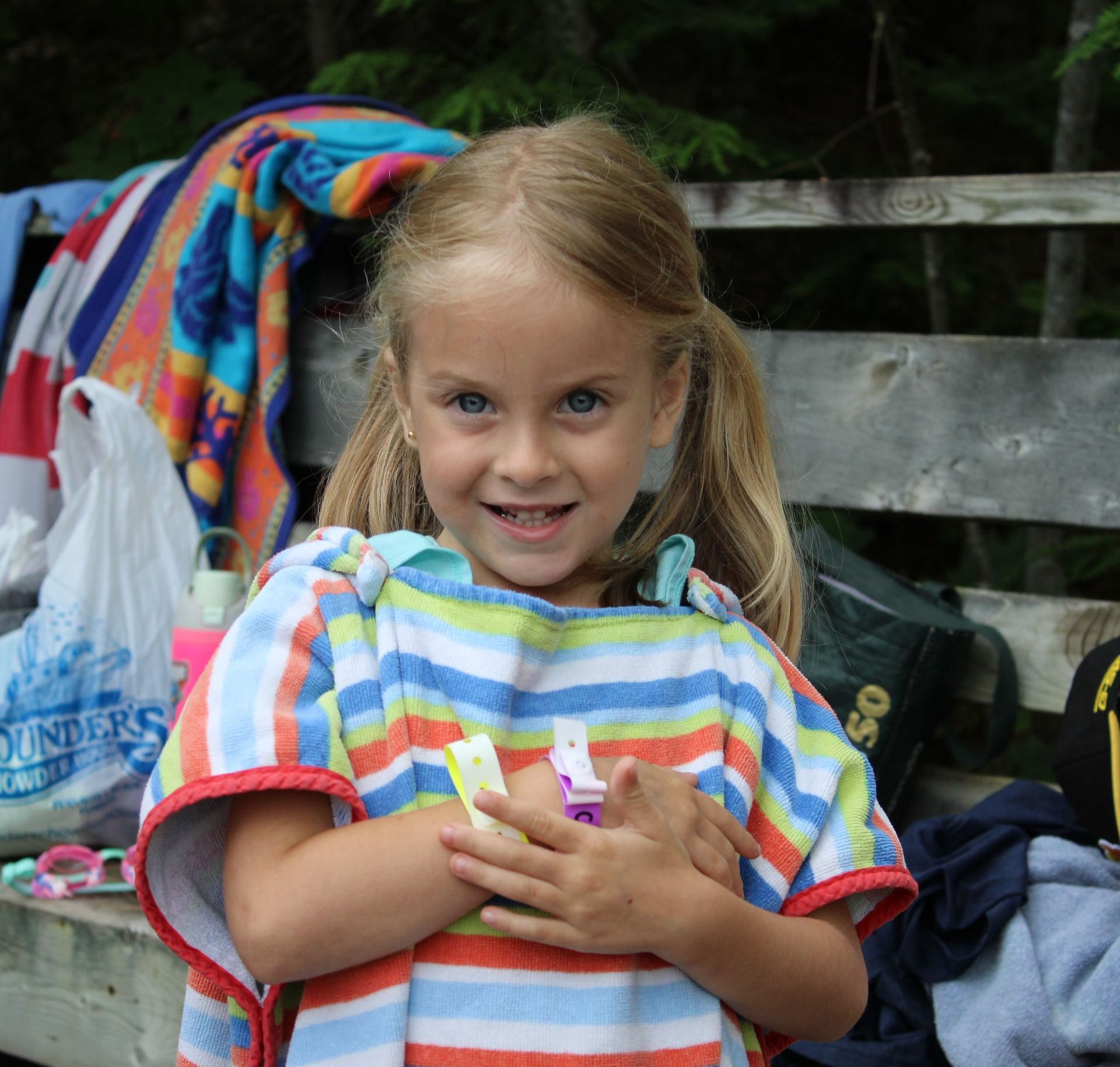 A young boy is blowing soap bubbles outside.