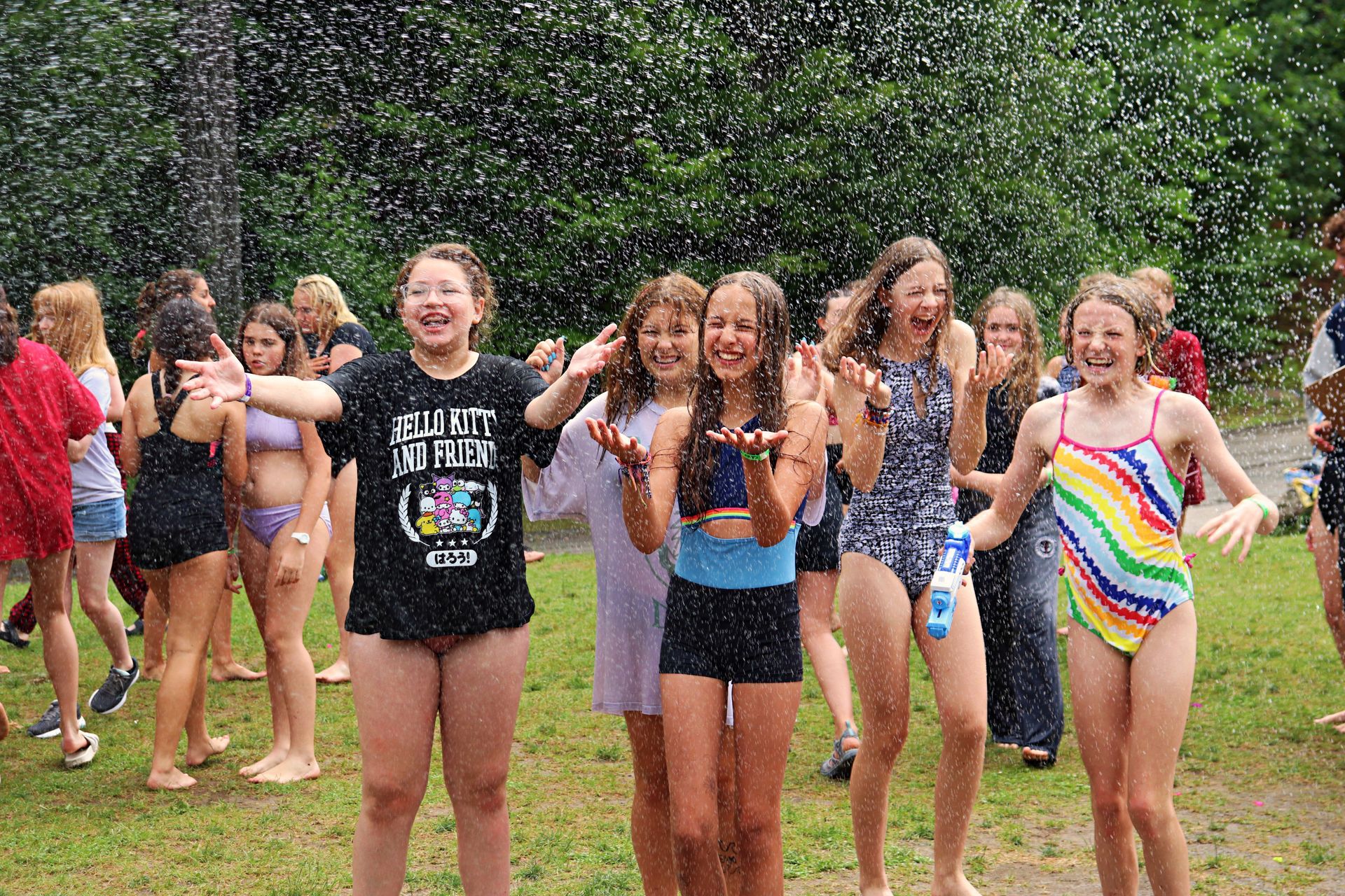 Campers having fun on a hot day with water play