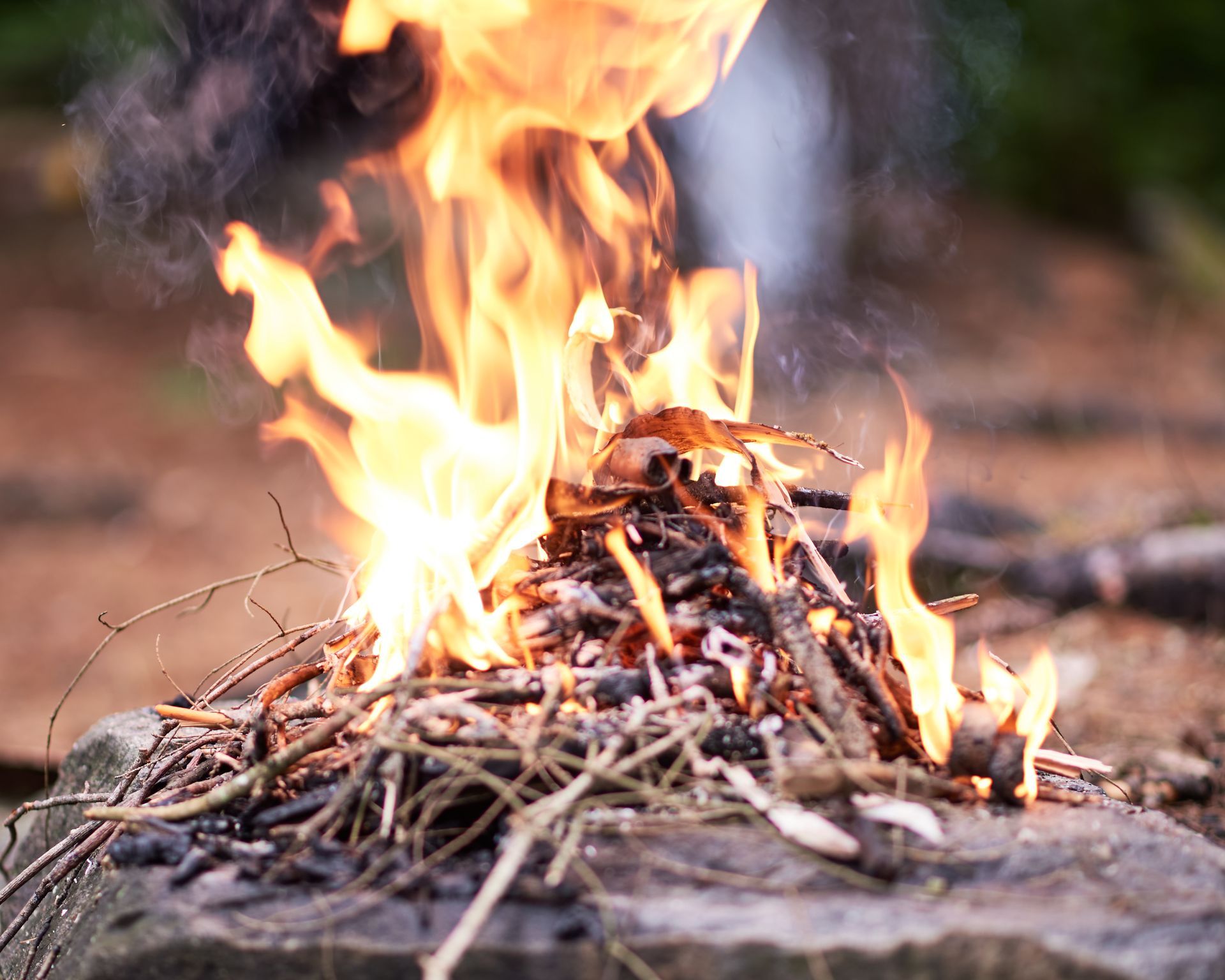 Close up image of an outdoor camp fire with flames.