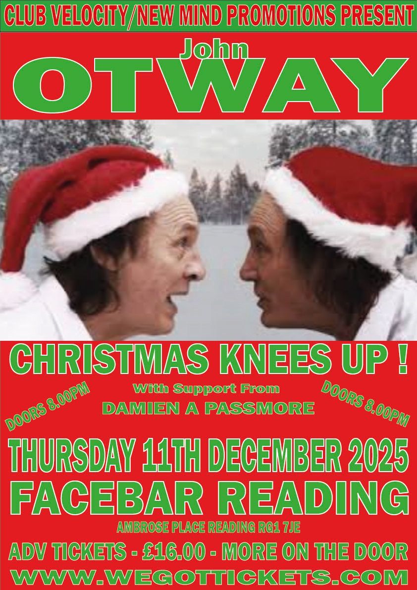 Two men wearing santa hats are looking at each other in the snow.