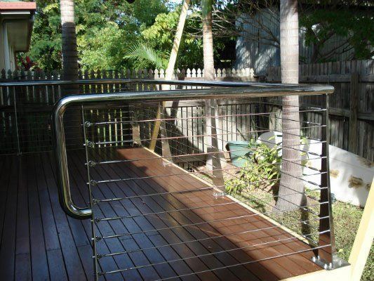 A Wooden Deck With A Stainless Steel Railing — Dalrymple Sheet Metal In Garbutt, QLD