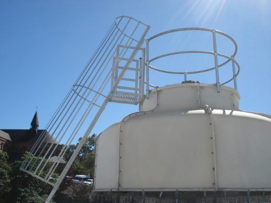 A White Building With A Ladder On Top Of It — Dalrymple Sheet Metal In Garbutt, QLD