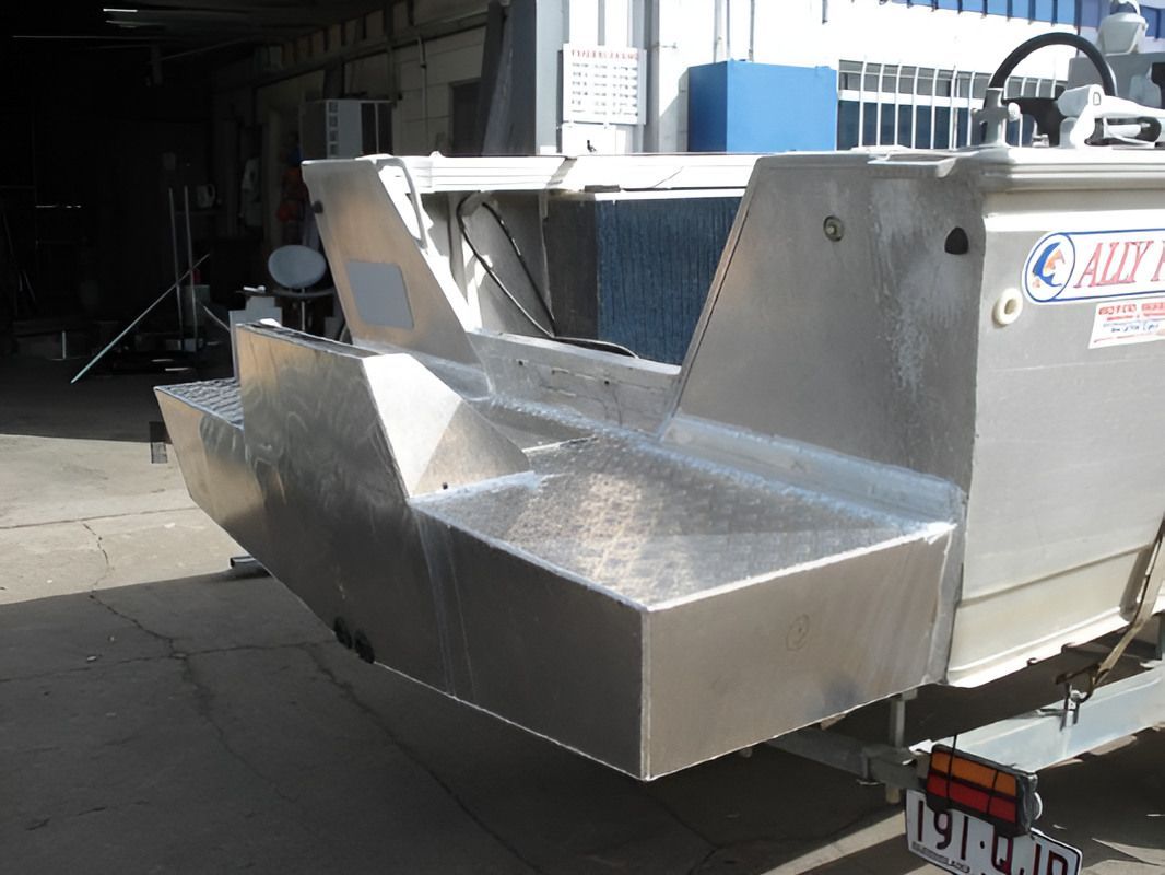 An Aluminum Boat Is Parked In A Garage — Dalrymple Sheet Metal In Garbutt, QLD