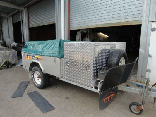 A Trailer Is Parked In Front Of A Garage Door — Dalrymple Sheet Metal In Garbutt, QLD