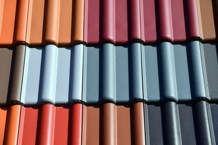 A row of different colored tiles on a roof