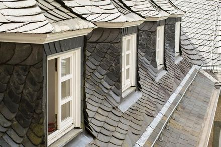 A row of windows on the roof of a building