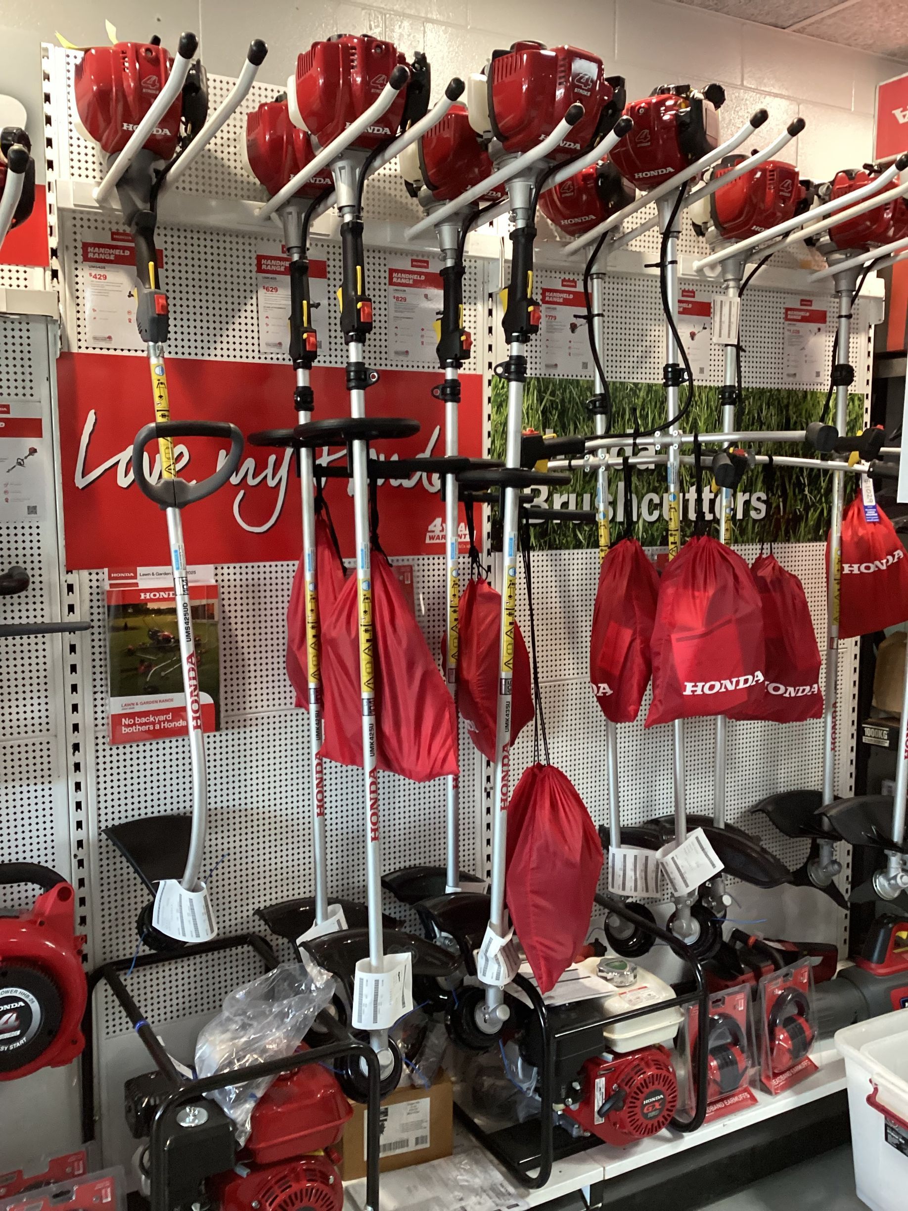 Worker Fixing Lawn Mower — Garden Tool Repairs In Bowen, QLD