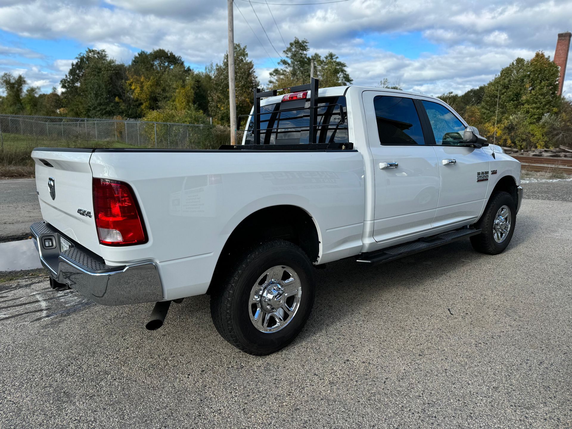 A white dodge ram truck is parked on the side of the road.