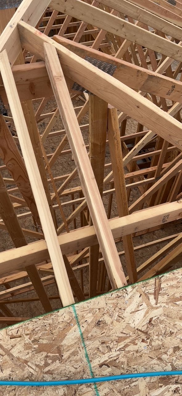 Wooden roof trusses under construction.