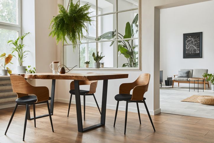 Stylish and botany interior of dining room with design craft wooden table