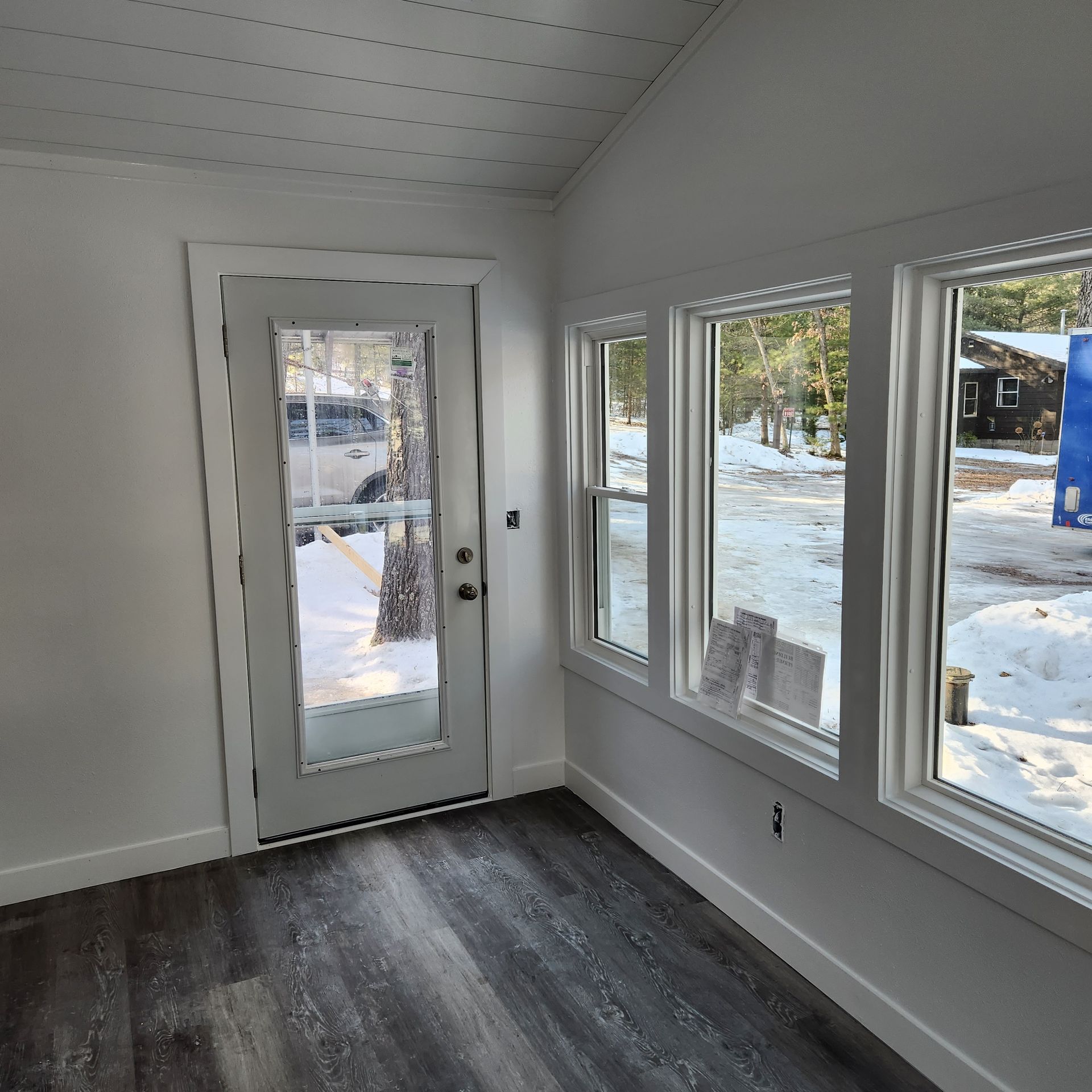 A room with a door and a lot of windows