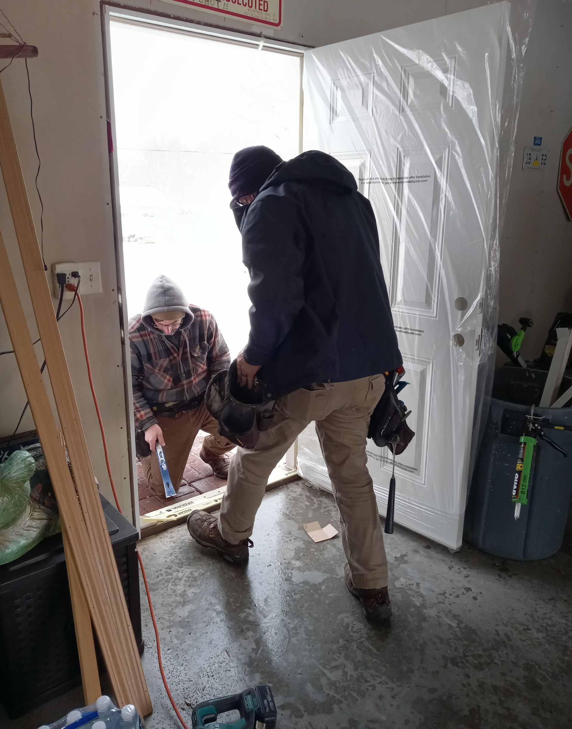 A man is carrying a bag into a doorway.