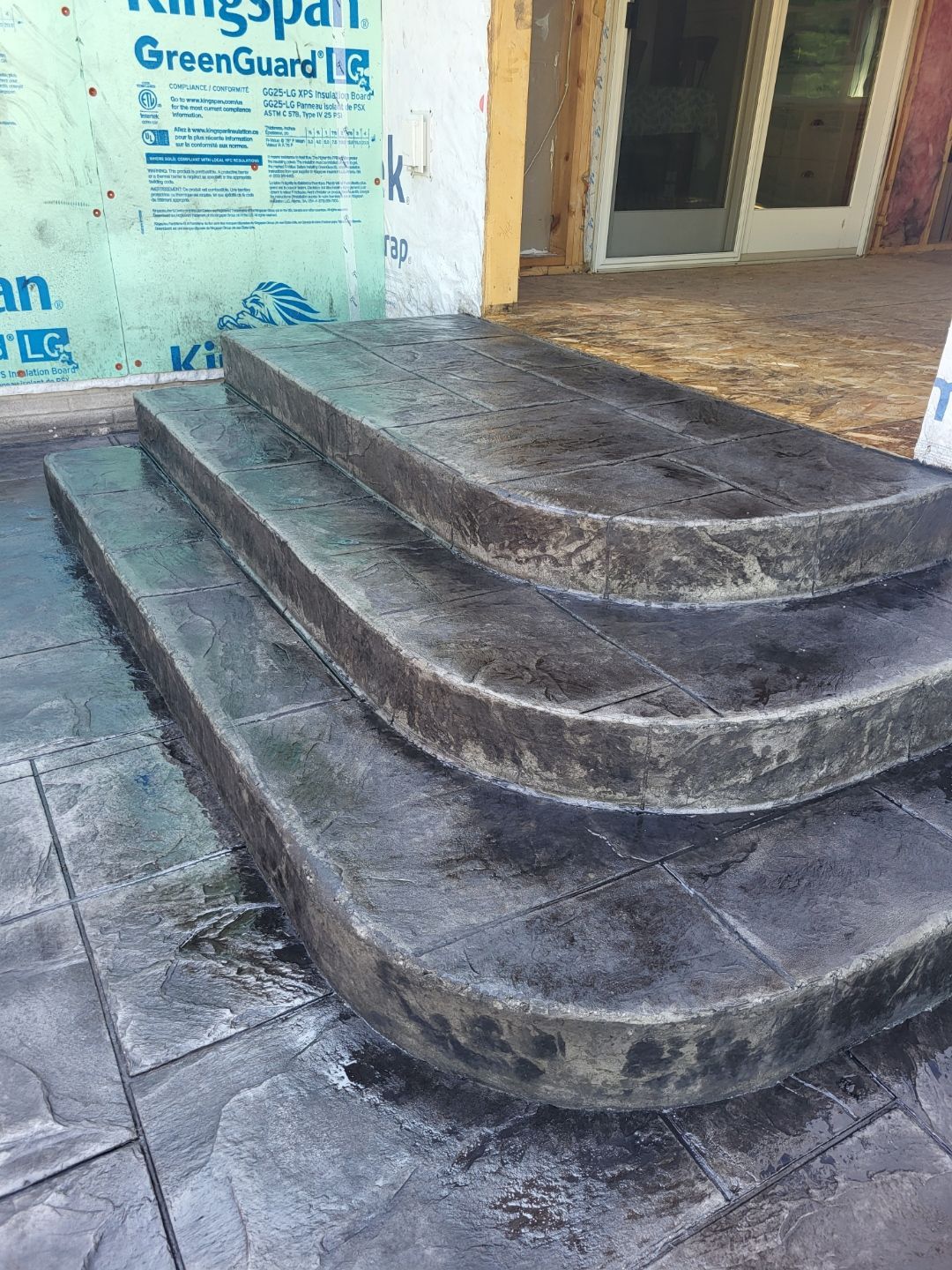 A concrete staircase is being built in front of a house.