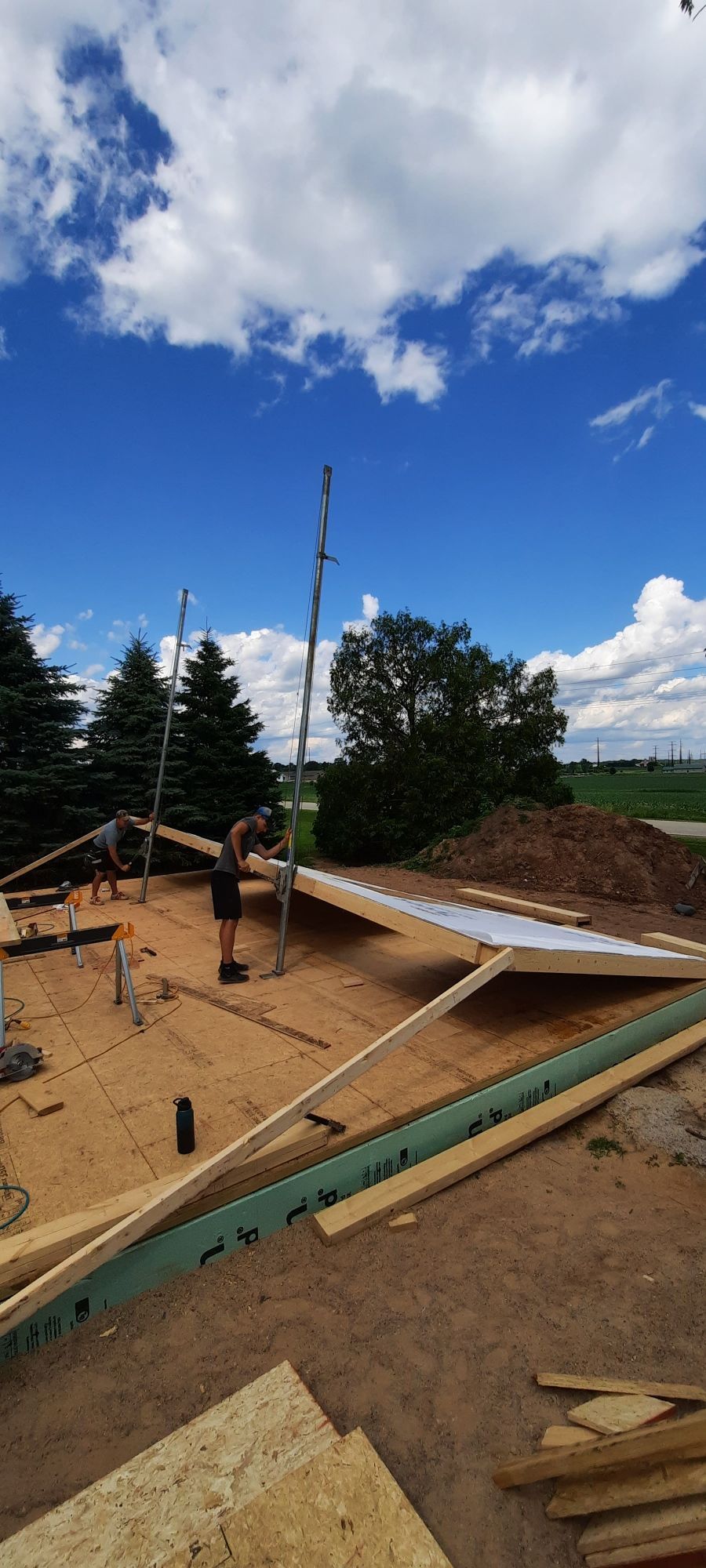 A group of people are working on a house under construction.