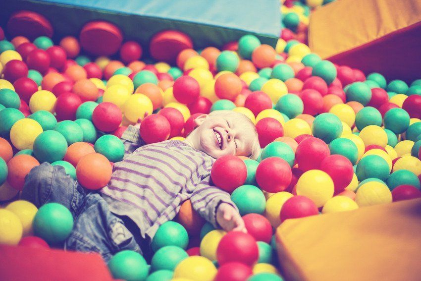 a kid playing with balls