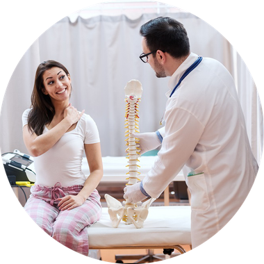 Chiropractor — Doctor Standing Next to His Patient and Holding Spine Model in Las Vegas, NV