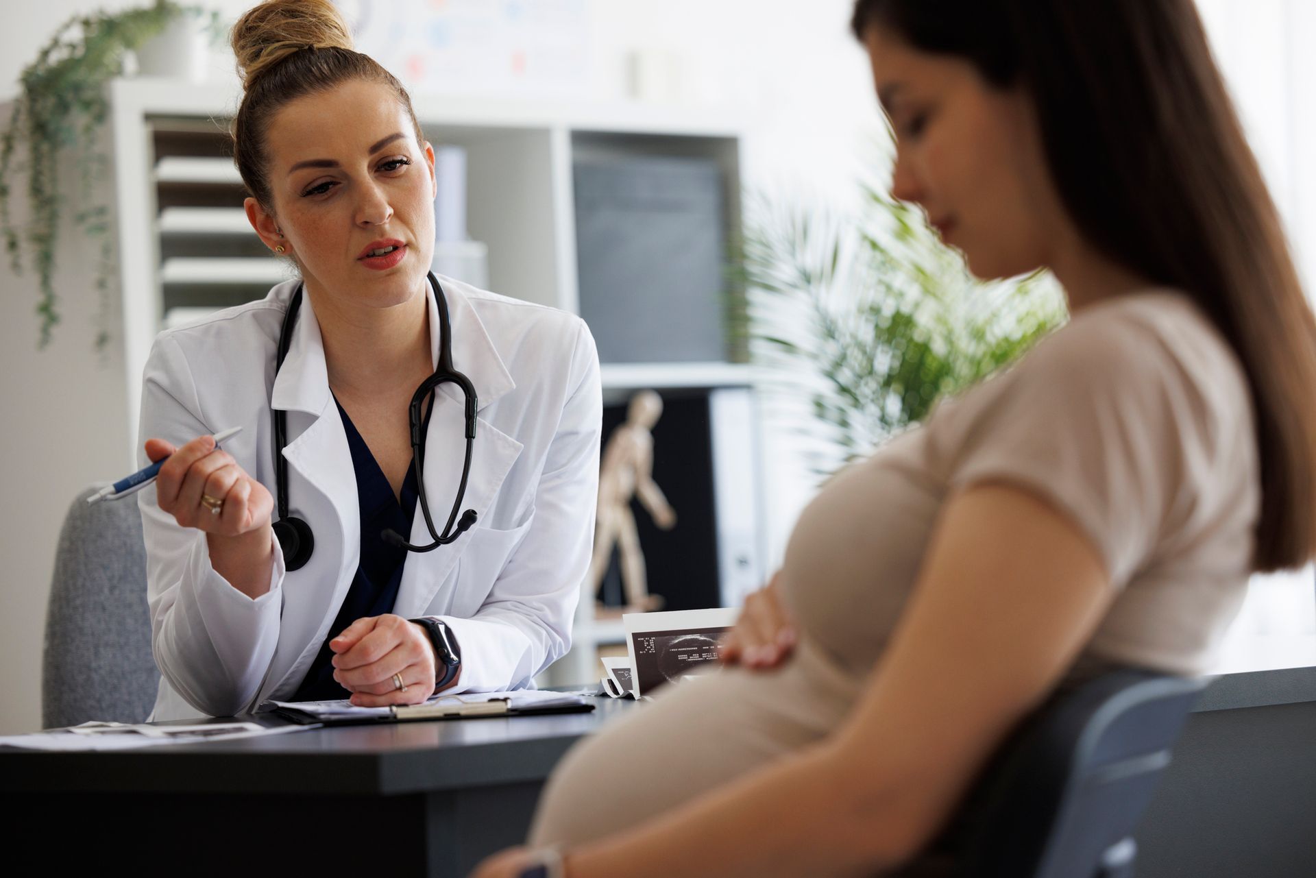 The gynecologist is consulting a pregnant patient in the clinic | ob/gyn services | San Antonio, TX.