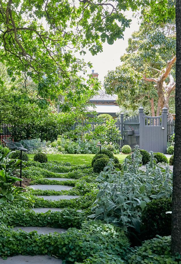 Modern home with pool, lounge area, and dark wood exterior. Sunny outdoor setting.