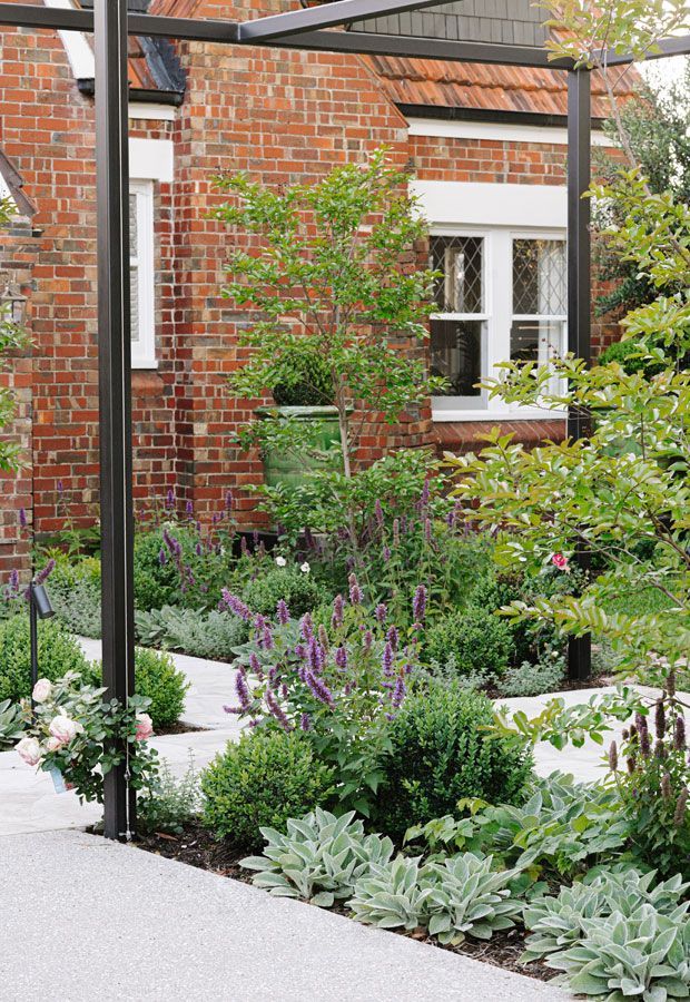 Swimming pool with turquoise water, wood deck, lounge chairs, and green trees under a blue sky.