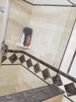A bathroom with a checkered floor and a mirror.