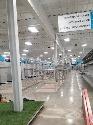 A large warehouse filled with lots of shelves and signs.