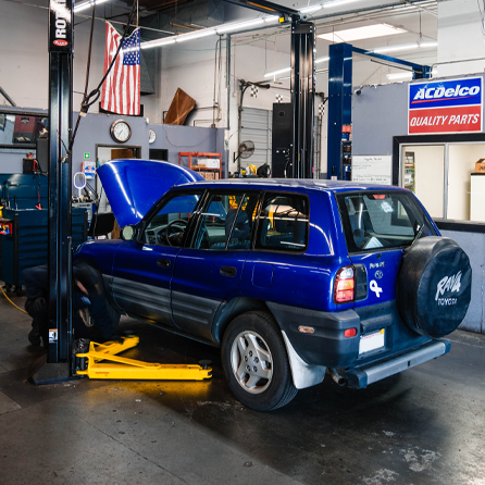 Blue car in garage | Driven Auto Care