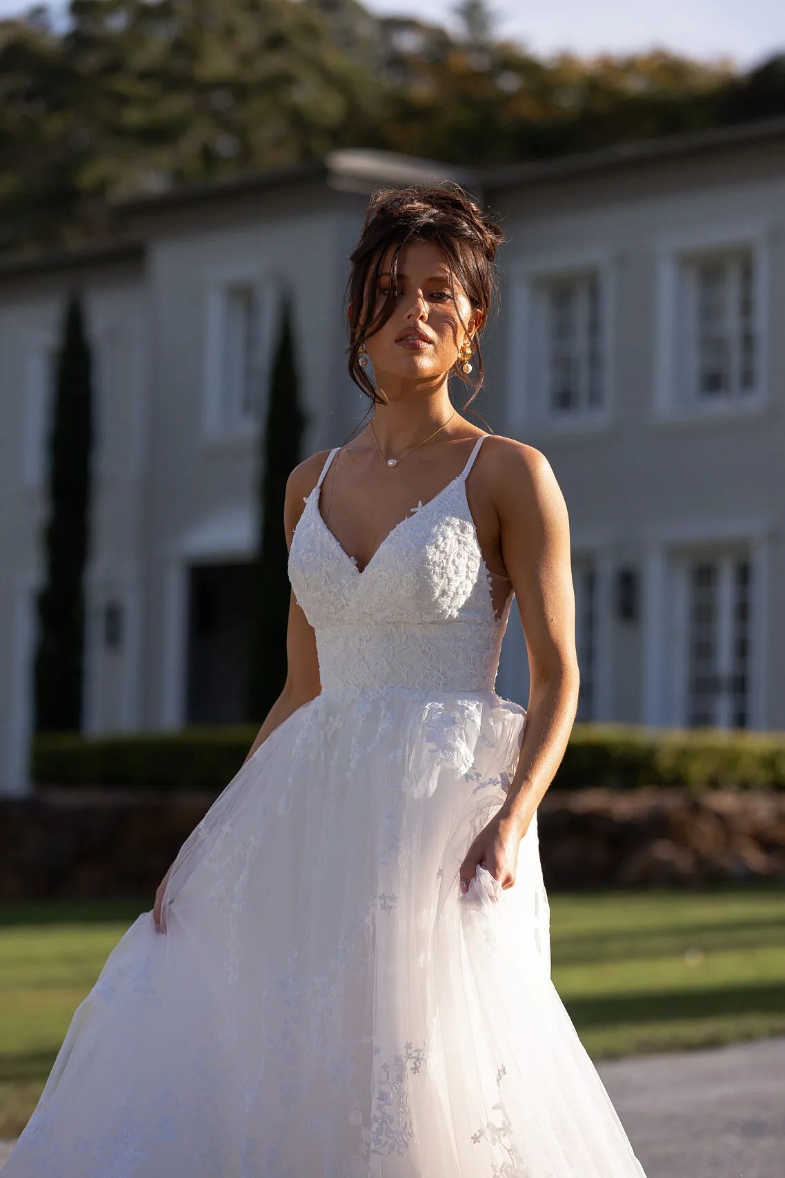 Fitted bodice bridal gown with full skirt in lace.