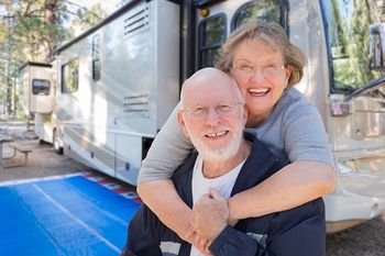 older couple outside of an rv