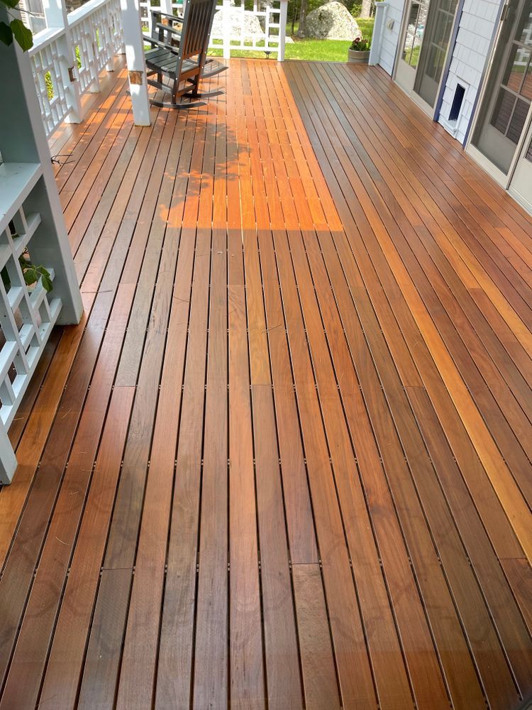 A wooden deck with a rocking chair on it.