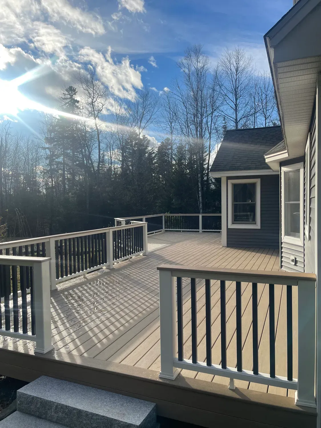 A house with a large deck and stairs leading to it