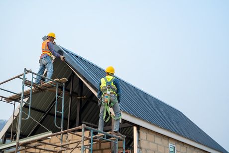 roofer installing metal roof