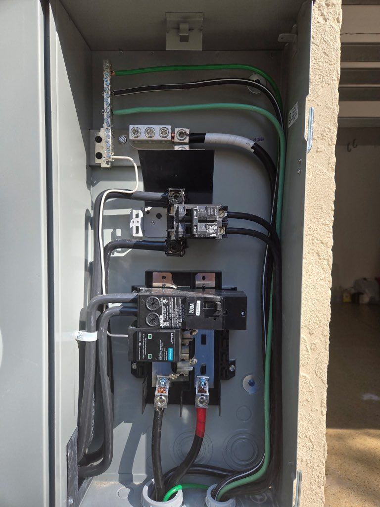 The inside of a electrical box with a lot of wires coming out of it.