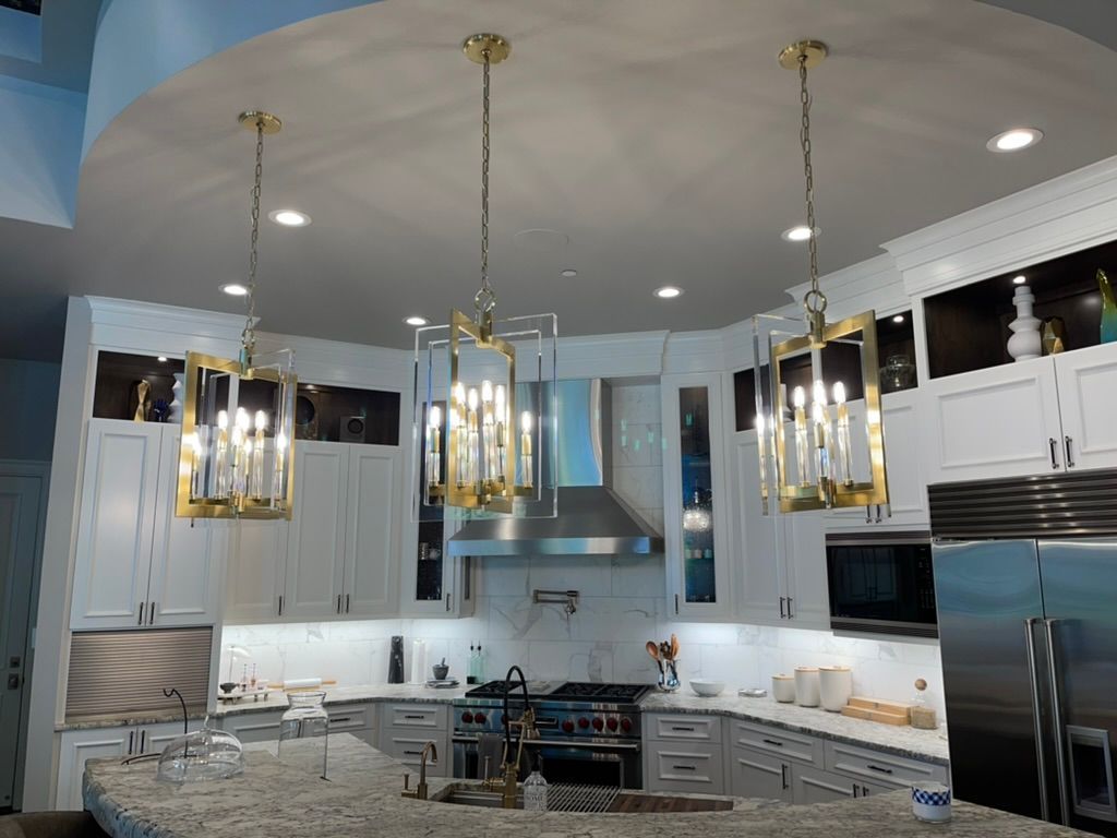Woman in straw hat smiles, holding wine glass near a lake.