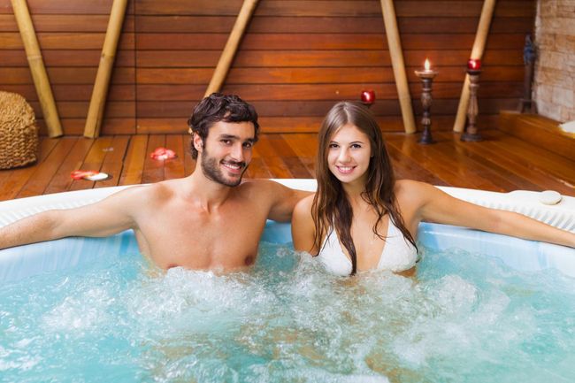 Couple Relaxing — Williamsville, NY — Creekside And Hot Tub And Sauna