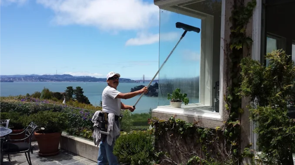 Window cleaners in Marin County professionally cleaning residential windows to prevent long-term gla